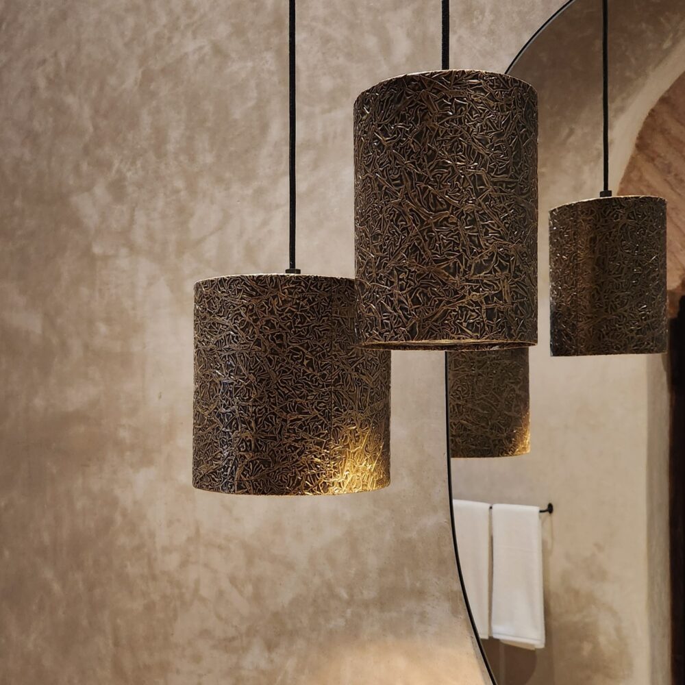 Textured brass pendant light: Cylindrical design and focused lighting