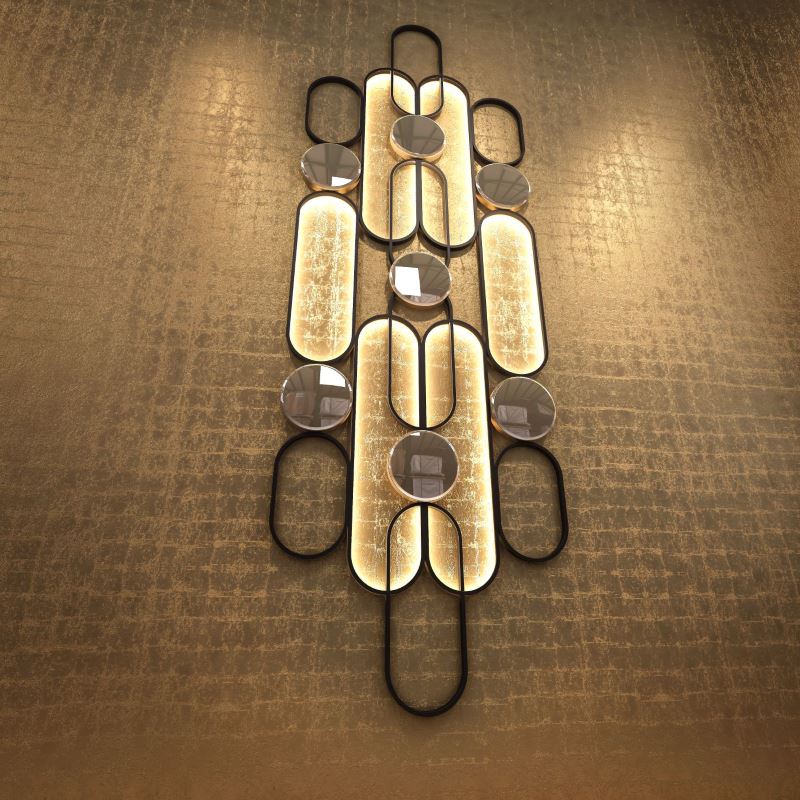 Large wall light sconce, 400 cm high. Black steel, bronze, and bronze mirrors. Indirect LED lighting and curved geometric forms.