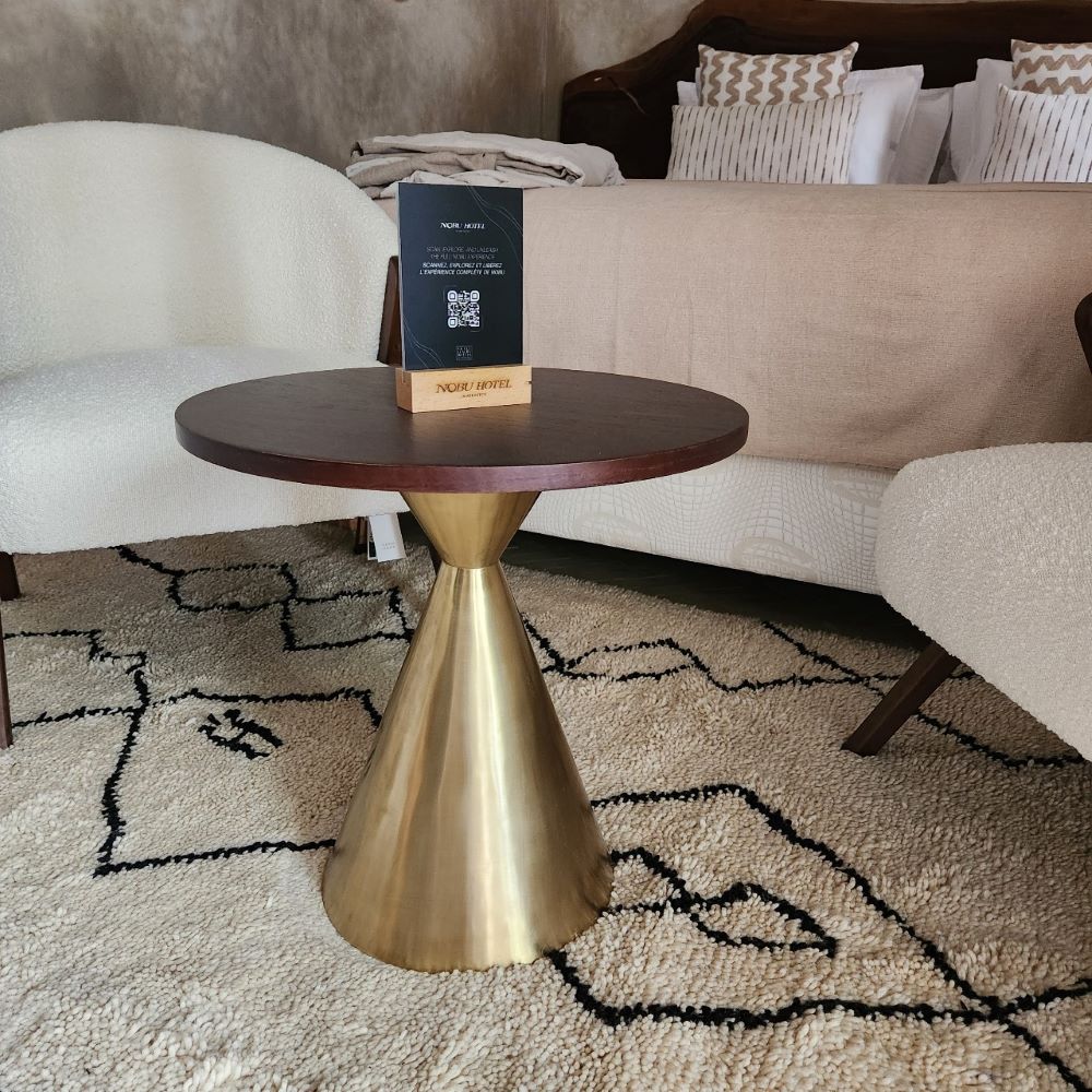 Pedestal table in brass with antique gold patina or gun barrel finish.