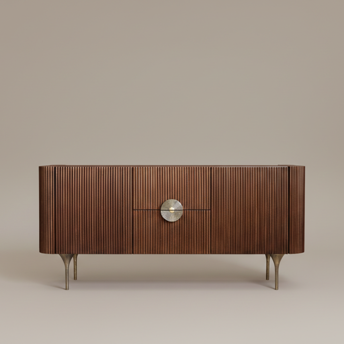 Handcrafted fluted oak and brass sideboard with circular handle and cast brass legs Fluted Oak and Brass Sideboard Specifications This fluted oak and brass sideboard stands out with an elongated architectural silhouette and a textured front composed of vertical wooden slats. The regular rhythm of the fluting is centered by a circular brass handle, creating a refined focal point. Slender, slightly flared cast-brass legs elevate the cabinet, introducing a balance of visual lightness and structural stability. Timber Veneer Fluting and Worked Metal Patinas The cabinet features oak veneer selected for its warm grain and lasting performance. The metal elements—including the central motif handle and cast base—feature a hand-applied patina that dialogues with the wood texture. You can explore the technique of fluting in architecture and woodworking. Furthermore, this interplay of materials enhances tactile warmth. Workshop Production of the Fluted Oak and Brass Sideboard Our artisans handcraft every fluted oak and brass sideboard individually in our local workshop. Skilled cabinetmakers assemble each vertical slat with precise joinery, ensuring crisp edges across the entire facade. Meanwhile, our metalworkers cast and finish the brass elements by hand. Consequently, subtle variations in tone confirm genuine handwork for every finished piece. Dimensions and Interior Arrangement Designed for versatile daily use, the interior combines two spacious drawers and two side doors to offer organized storage. Measuring Height 80 cm × Length 170 cm × Depth 45 cm, it anchors living rooms or dining areas. You can display it as a focal piece or pair it with our broader selection of handcrafted side tables and architectural floor lamps. Care and Maintenance Guidelines Handcrafted fluted oak and brass sideboard with circular handle and cast brass legs