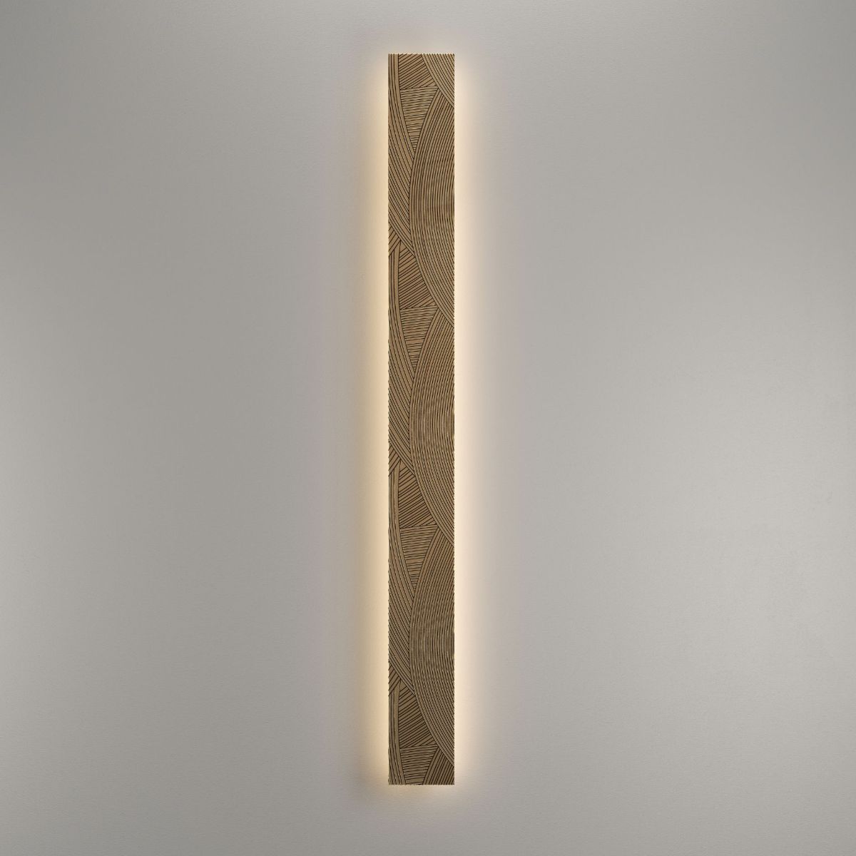 Handcrafted engraved brass wall light with indirect LED halo illumination